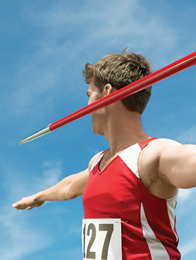 a person posing in preparation for performing a javelin throw