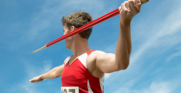 a close up of a man preparing to throw a javelin