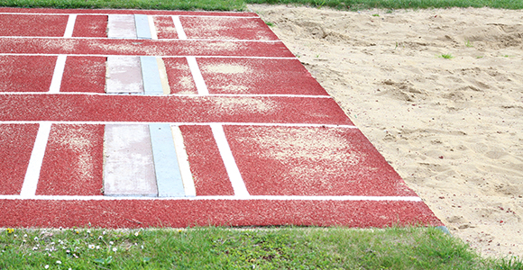 a close up of a triple jump track with the lines for the last jump